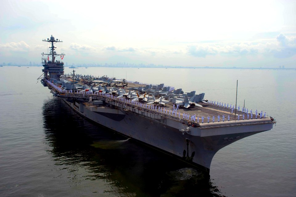 US Navy 100908-N-6720T-015 Sailors aboard USS George Washington (CVN 73) man the rails as the ship raises one of its 90,000-pound anchors before d