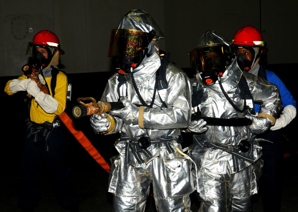 US Navy 100910-N-7908T-015 Sailors assigned to the air department of the aircraft carrier USS George H.W. Bush (CVN 77) man hoses during a drill in