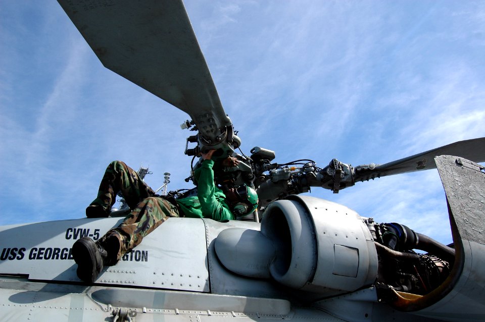 US Navy 100909-N-7191M-024 Aviation Machinist's Mate 3rd Class Daniel Wilson, from New Orleans, performs corrosion treatment on the rotor of an SH