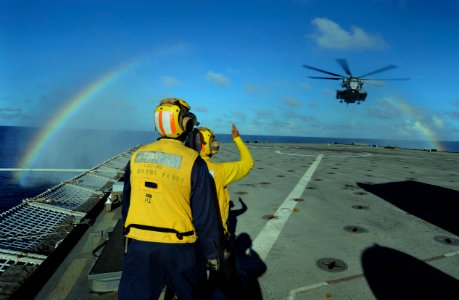 US Navy 100908-N-8335D-661 Sailors direct a CH-53E Super Stallion helicopter as it lands on the flight deck of USS Harpers Ferry (LSD 49) photo