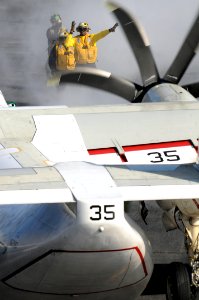 US Navy 100913-N-7605J-011 Aviation Boatswain's Mate (Handling) 3rd Class Alexis Fernandez, left, observes as Aviation Boatswain's Mate (Handling)