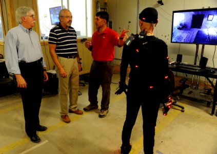 US Navy 100914-N-7676W-065 Clarke Lethin, explains to Dr. Walter F. Jones, left, and George Solhan how a virtual puppeteer interacts with Marines