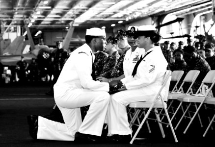US Navy 100915-N-6003P-091 Aviation Structural Mechanic Airman Ismayda Acquie receives a flag and condolences from Chief Machinist's Mate (Sel.) Jo