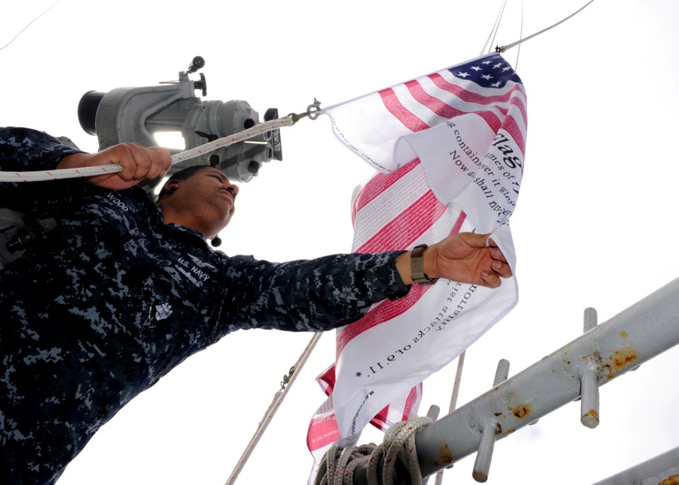 US Navy 100910-N-4973M-050 Aviation Support Equipment Technician 1st Class Kenneth Wood lies the Flag of Honor