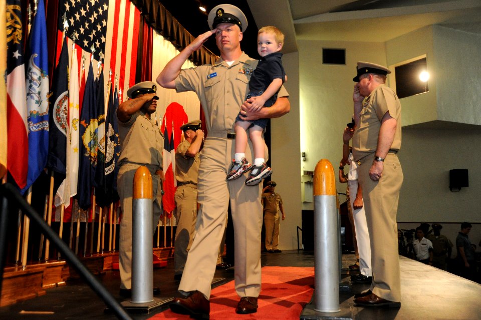 US Navy 100916-N-2858S-372 Chief Aviation Structural Mechanic Vincent Rock is piped through side boys with his son for the first time as a chief pe