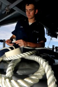 US Navy 100910-N-7103C-009 Boatswain's Mate 3rd Class Nate Long, from San Diego, splices a lifeline on the fantail of the aircraft carrier USS Geor photo