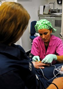 US Navy 100910-N-2908M-006 Hospital Corpsman Alyssa Toscano prepares a patient for surgery aboard USS Kearsarge (LHD 3) photo