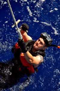 US Navy 100914-N-7293M-014 Fire Controlman 2nd Class Collin Reed gives a thumbs-up to signal a successful insertion into the water from the bow of