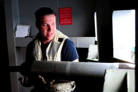 US Navy 100913-N-5503T-009 Operations Specialist 3rd Class Steven Sittner holds the Nixie module as it is reeled onto the fantail of the aircraft c