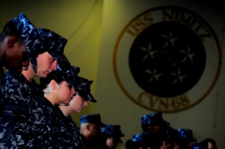 US Navy 100911-N-2918M-097 Sailors aboard the aircraft carrier USS Nimitz (CVN 68) bow their heads during a memorial service in honor of the victim