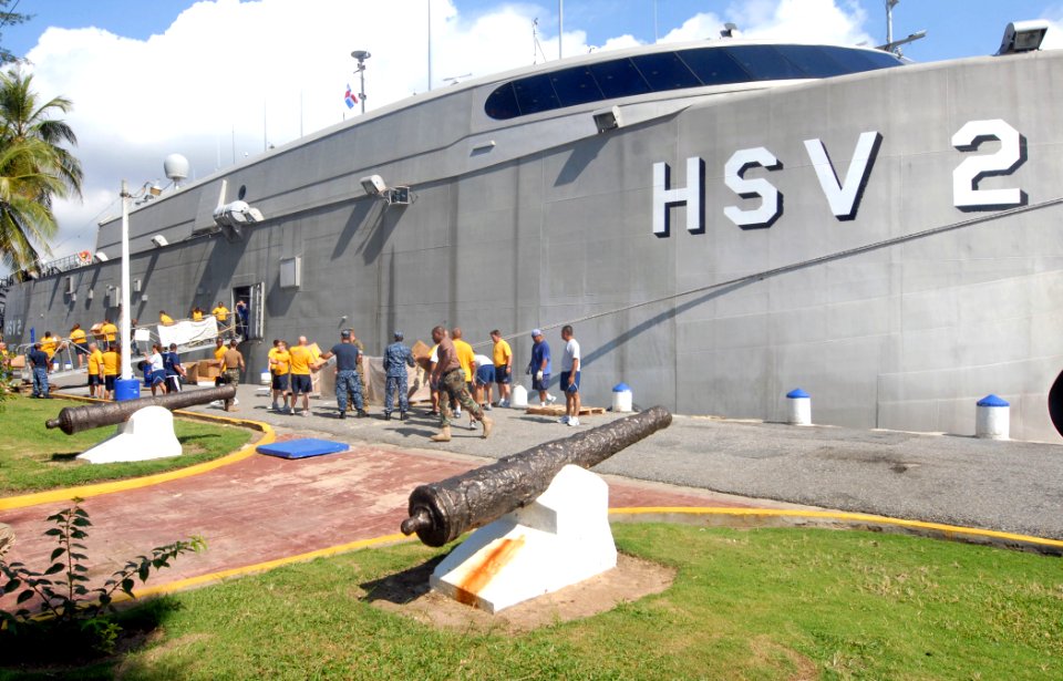 US Navy 100919-N-4971L-024 Personnel embarked aboard High Speed Vessel Swift (HSV 2) unload pallets of Project Handclasp aid to be donated to reli
