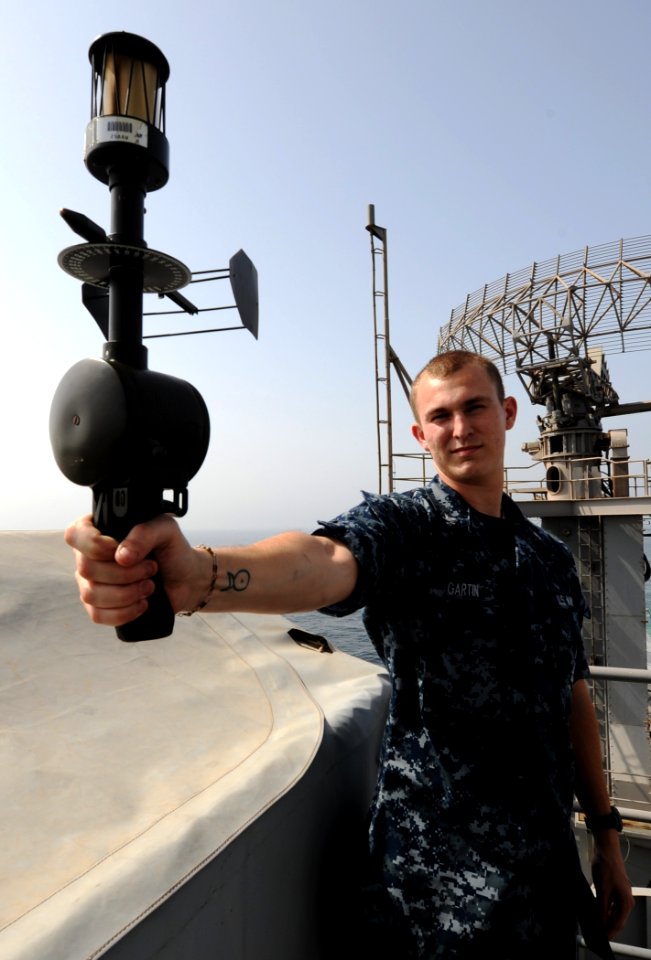 US Navy 100918-N-4135M-074 Aerographer's Mate 3rd Class Dale Gartin, from La Grange, Texas, uses an anemometer to measure the relative winds during