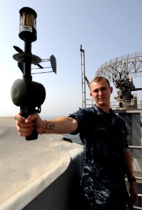 US Navy 100918-N-4135M-074 Aerographer's Mate 3rd Class Dale Gartin, from La Grange, Texas, uses an anemometer to measure the relative winds during