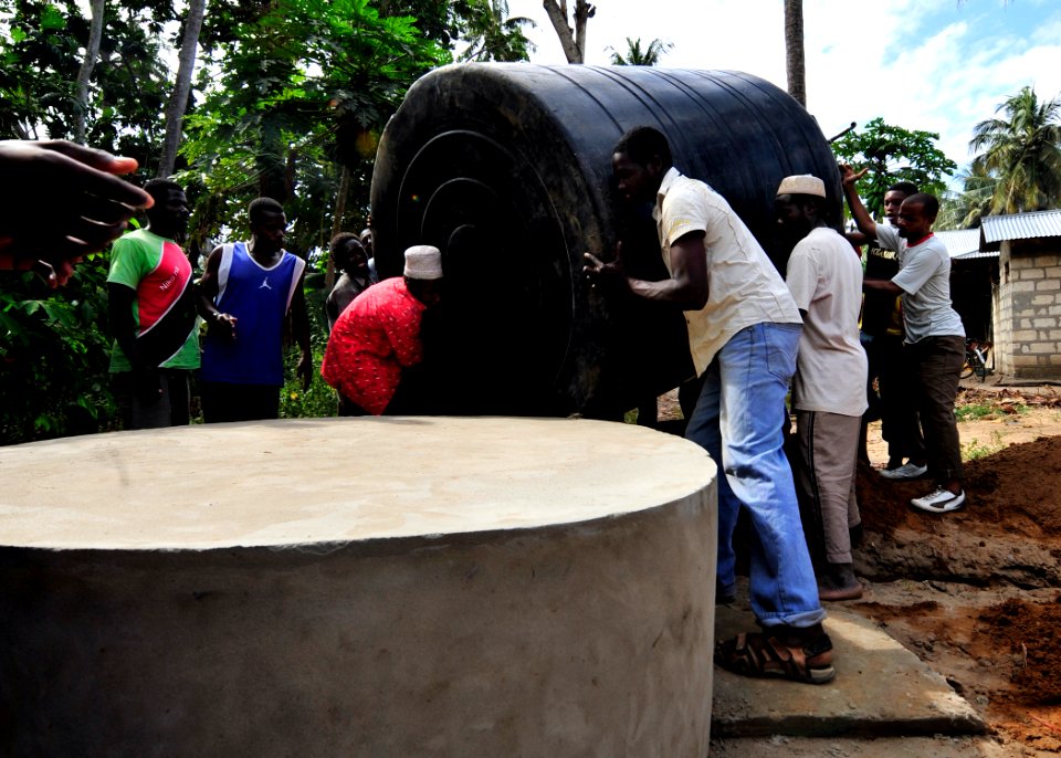 US Navy 100913-N-7241L-007 Residents of Fundo Island, a small islet that is part of Pemba Island, carry a 5,000-liter water cistern to a concrete s