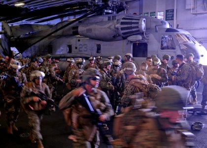 US Navy 100919-N-9950J-187 Marines assigned to the 31st Marine Expeditionary Unit (31st MEU) prepare for a simulated air raid aboard the forward-de photo