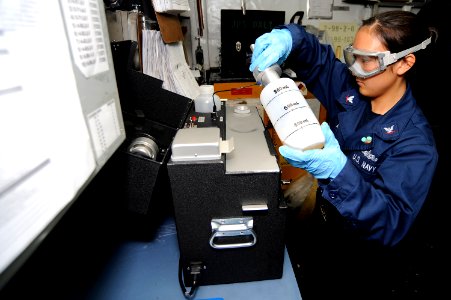 US Navy 100913-N-8335D-040 Engineman 3rd Class Courtney Arce uses a combined-contaminated fuel detector to test fuel for impurities in the oil lab