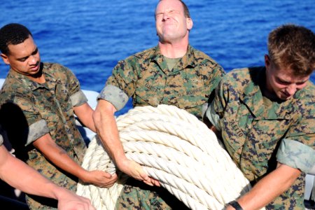 US Navy 100915-N-5538K-128 Marines assigned to the 31st Marine Expeditionary Unit (31st MEU) carry a 600-foot Kevlar mooring line to the fantail of photo