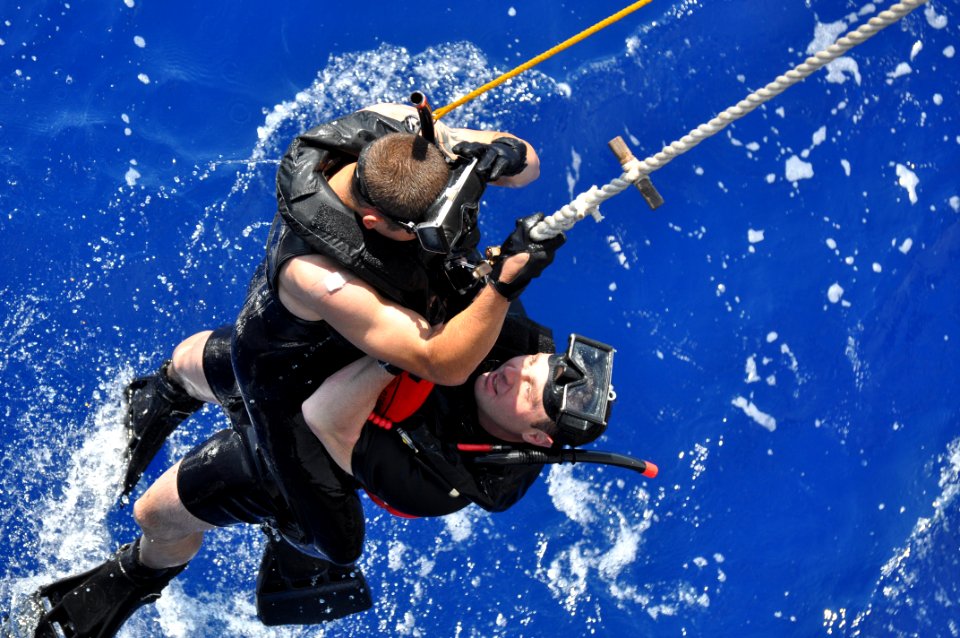 US Navy 100914-N-7293M-042 Lt. j.g. Daniel Cooper and search and rescue swimmer Seaman Apprentice Ryan Owens take turns rescuing an injured swimmer