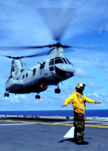 US Navy 100919-N-9950J-450 Aviation Boatswain's Mate (Handling) Airman Bernard Ugalde directs the lift off of a CH-46E Sea Knight helicopter aboard
