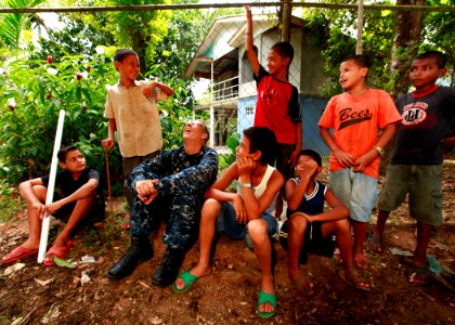 US Navy 100921-M-6740B-304 U.S. Navy Capt. Thomas M. Negus, commodore of Operation Continuing Promise 2010, visits with local Nicaraguan children a photo