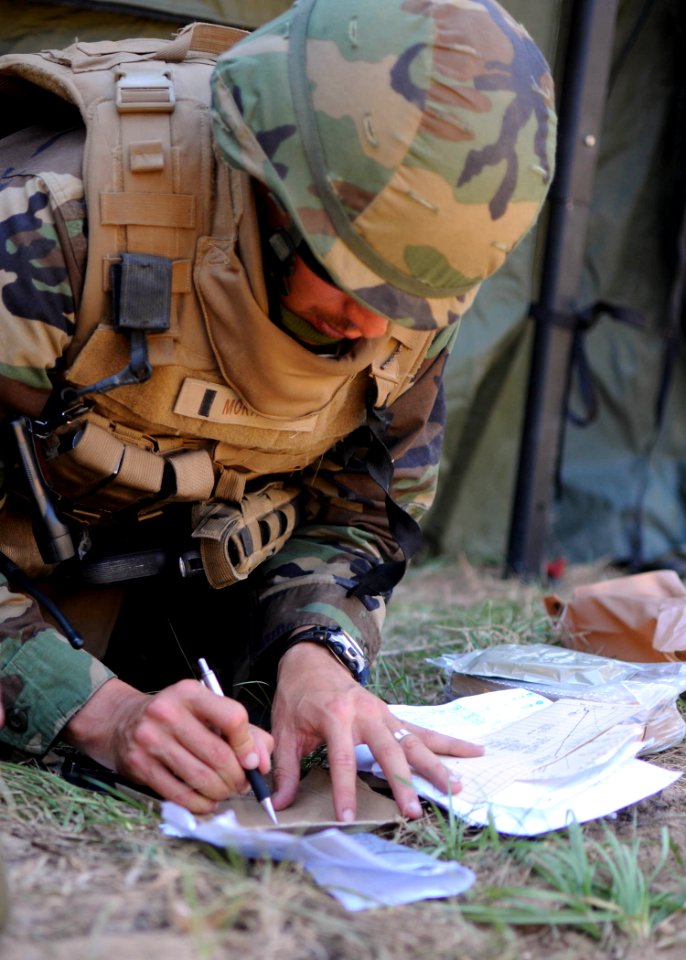 US Navy 101014-N-4440L-484 t. j.g. Jose Mora, assigned to the air detail of Naval Mobile Construction Battalion (NMCB) 74, uses range cards to draw