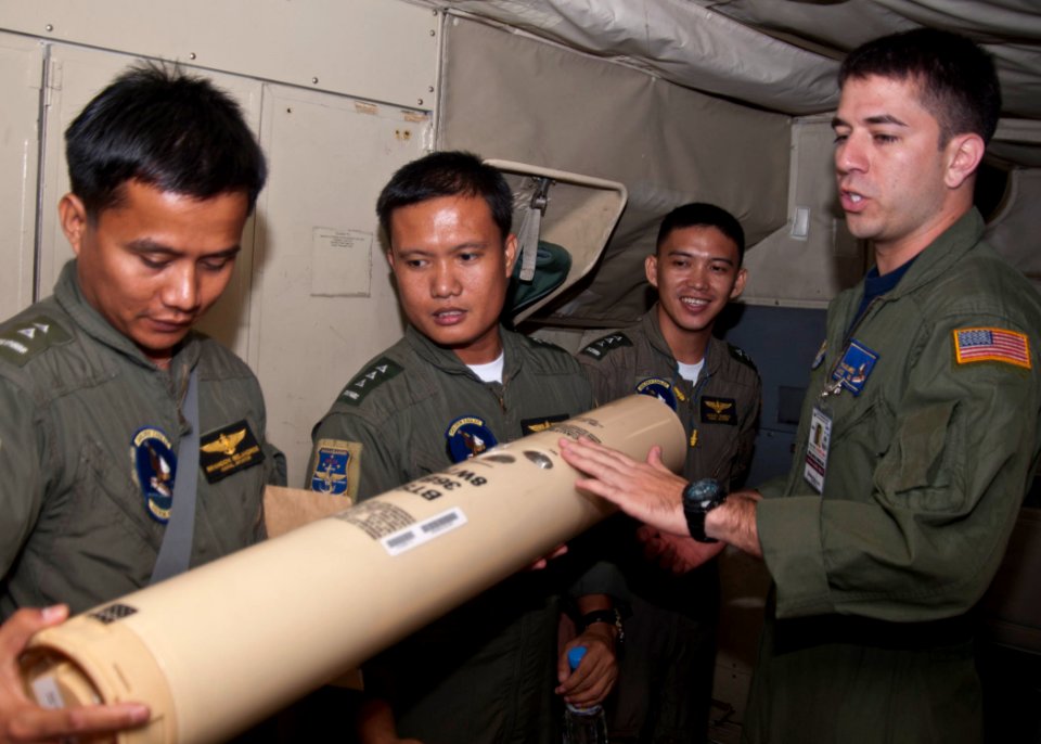 US Navy 101013-N-6770T-237 Navy Air Crewman 2nd Class Rollado Mireless, assigned to Patrol Squadron (VP) 9, explains sonobouys aboard a P-3C Orion