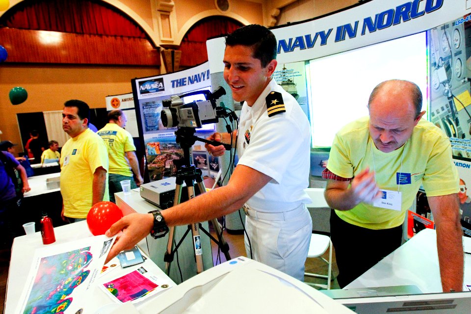 US Navy 101013-N-8863V-619 Lt. William Schindele, center, fleet liaison officer at Naval Surface Warfare Center, Corona Division, presents still im
