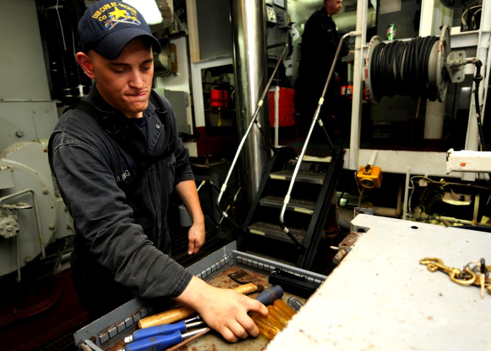 US Navy 101018-N-5016P-251 Gas Turbine System Technician (Mechanical) Fireman Noah Seiling sorts through his toolbox aboard the guided-missile crui
