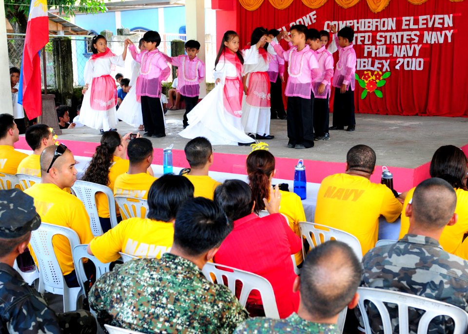 US Navy 101014-N-5538K-046 Sailors assigned to Amphibious Squadron (PHIBRON) 11 watch students from San Esteban Elementary School perform a traditi