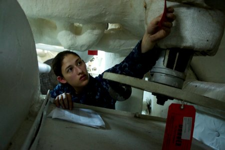 US Navy 101013-N-9643K-954 Machinists Mate 3rd Class Jyssica Gilson verifies lockout or tagedout systems undergoing maintenance in Bon Homme Richar