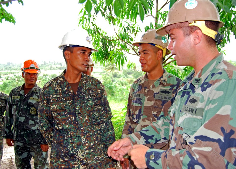 US Navy 101018-N-8539M-382 Seabees assigned to Naval Mobile Construction Battallion (NMCB) 11, talk with members of the Naval Construction Brigade