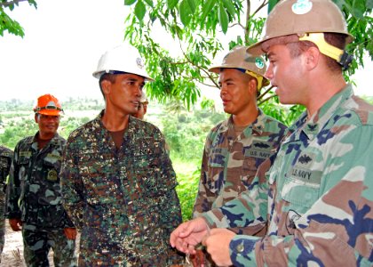US Navy 101018-N-8539M-382 Seabees assigned to Naval Mobile Construction Battallion (NMCB) 11, talk with members of the Naval Construction Brigade