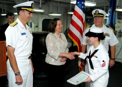 US Navy 101014-N-0120A-071 Leslie A. Bassett, center, charge'd affaires of the U.S. Embassy, congratulates Electrician's Mate Fireman Marianne Broo