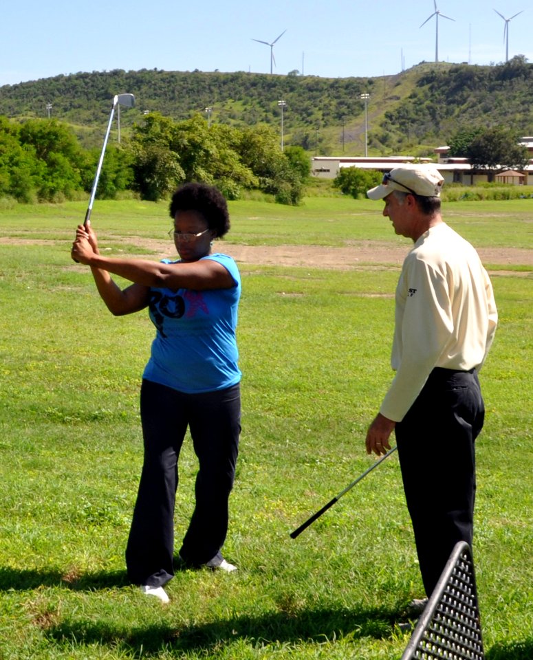 US Navy 101014-N-8241M-016 Professional golfer Jon Fine helps service members at Naval Station Guantanamo Bay Cuba with their golf game