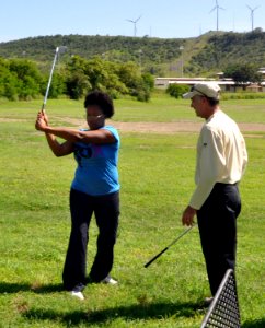 US Navy 101014-N-8241M-016 Professional golfer Jon Fine helps service members at Naval Station Guantanamo Bay Cuba with their golf game