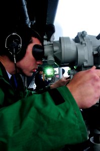 US Navy 101018-N-6006S-234 Boatswain's Mate Seaman Nick Storgion stands the forward look-out watch aboard the aircraft carrier USS Carl Vinson (CVN