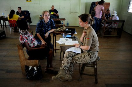 US Navy 101018-N-9964S-079 Lt. Cmdr. Tara Wilson and German navy Cmdr. Diana Seeman speak with a Guyanan woman about her health during a Continuing