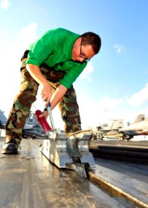 US Navy 101014-N-0569K-032 Aviation Boatswain's Mate (Equipment) Airman Recruit Joe R. Case performs pre-operation maintenance on a catapult on the
