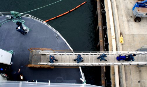 US Navy 101014-N-9643K-176 Sailors assigned to the amphibious assault ship USS Bonhomme Richard (LHD 6) walk across the ramp from Berthing and Mess