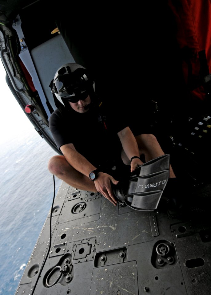 US Navy 101014-N-5016P-167 Naval Air Crewman 2nd Class Wesley Evans, assigned to Helicopter Sea Combat Squadron (HSC) 12, dons his rescue swimmer g