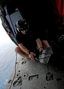 US Navy 101014-N-5016P-167 Naval Air Crewman 2nd Class Wesley Evans, assigned to Helicopter Sea Combat Squadron (HSC) 12, dons his rescue swimmer g