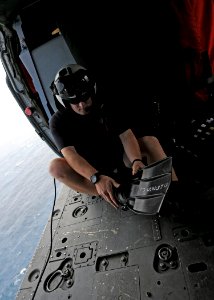 US Navy 101014-N-5016P-167 Naval Air Crewman 2nd Class Wesley Evans, assigned to Helicopter Sea Combat Squadron (HSC) 12, dons his rescue swimmer g photo