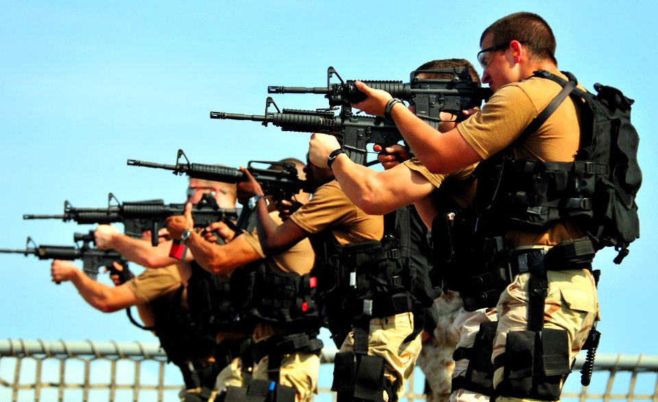 US Navy 101018-N-7948R-415 Members of a visit, board, search and seizure team fire M-4 rifles during weapons training aboard the amphibious dock la