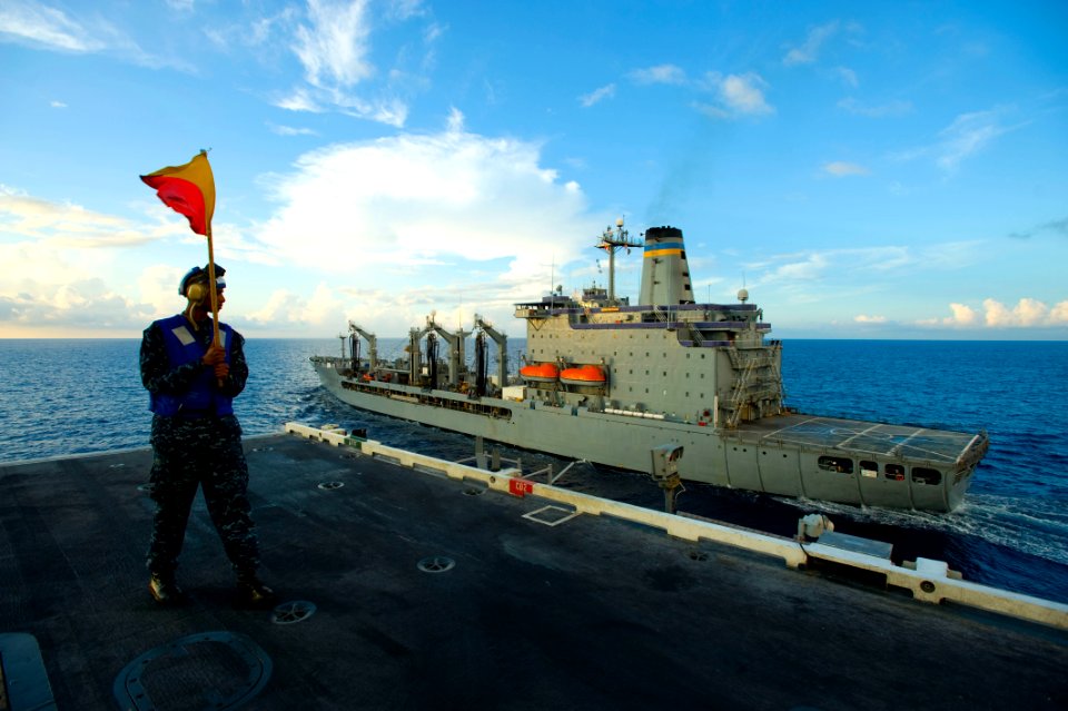 US Navy 101014-N-6720T-042 Quartermaster Seaman Gaius Iriaka, from New York, carries a signal flag aboard the aircraft carrier USS George Washingto