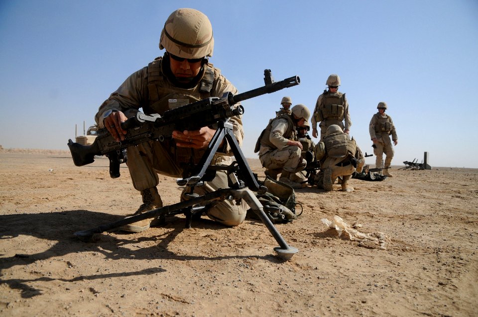 US Navy 101016-N-0475R-098 Construction Electrician 2nd Class Daniel Garcia, left, sets up an M-240 machine gun
