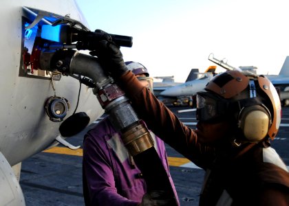 US Navy 101017-N-6632S-133 Airman Alejandro Henriquez, from Electronic Attack Squadron (VAQ) 141, checks the fuel flow indicator on an EA-18G Growl
