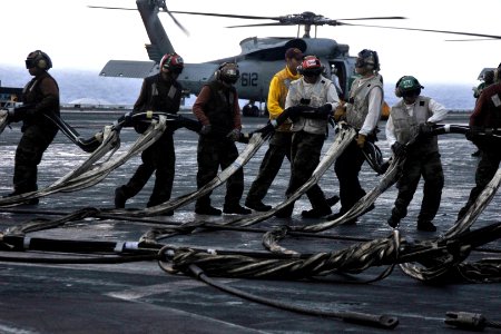 US Navy 101016-N-7103C-014 Sailors pull the barricade netting to a staging area on the flight deck during a barricade drill aboard the aircraft car