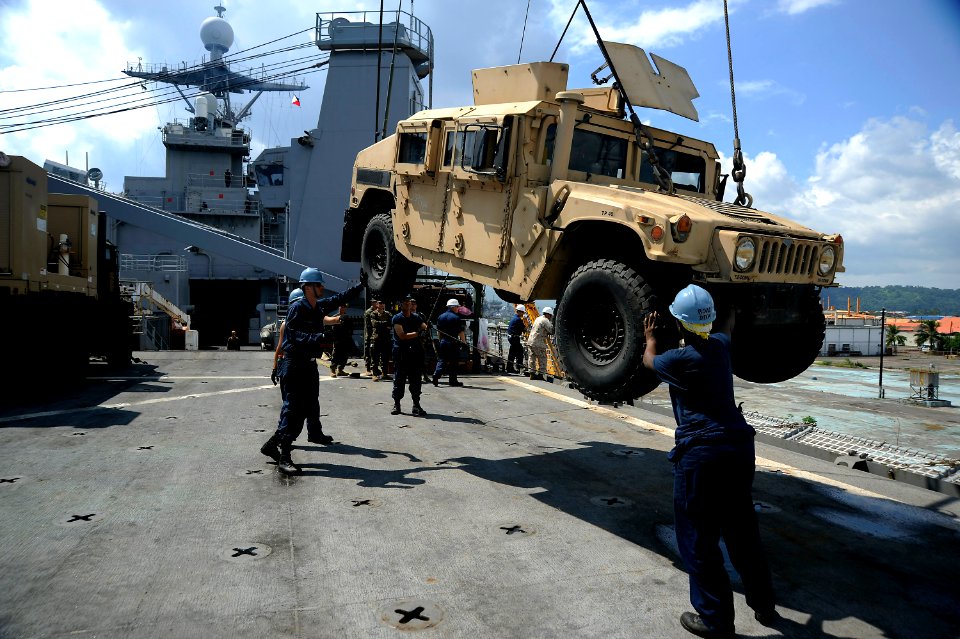 US Navy 101016-N-8335D-529 ailors maneuver a Humvee assigned to the 31st Marine Expeditionary Unit (31st MEU) being craned aboard the amphibious do