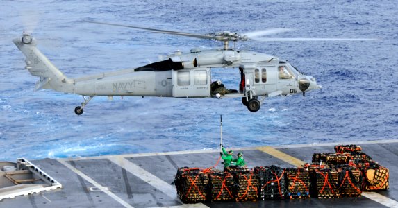 US Navy 101020-N-7103C-023 Sailors attach a pole pendant to an MH-60S Sea Hawk heliopter assigned to the Island Knights of Helicopter Combat Suppor