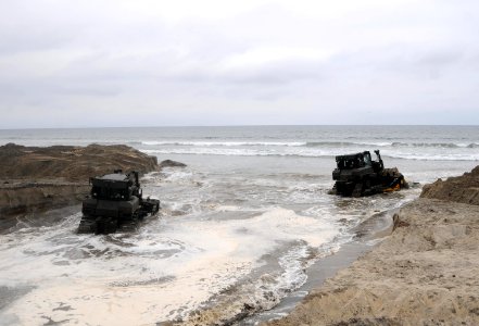 US Navy 101016-N-1786N-291 eabees assigned to Amphibious Construction Battalion (ACB) 1 use civil engineer support equipment to clear a landing are